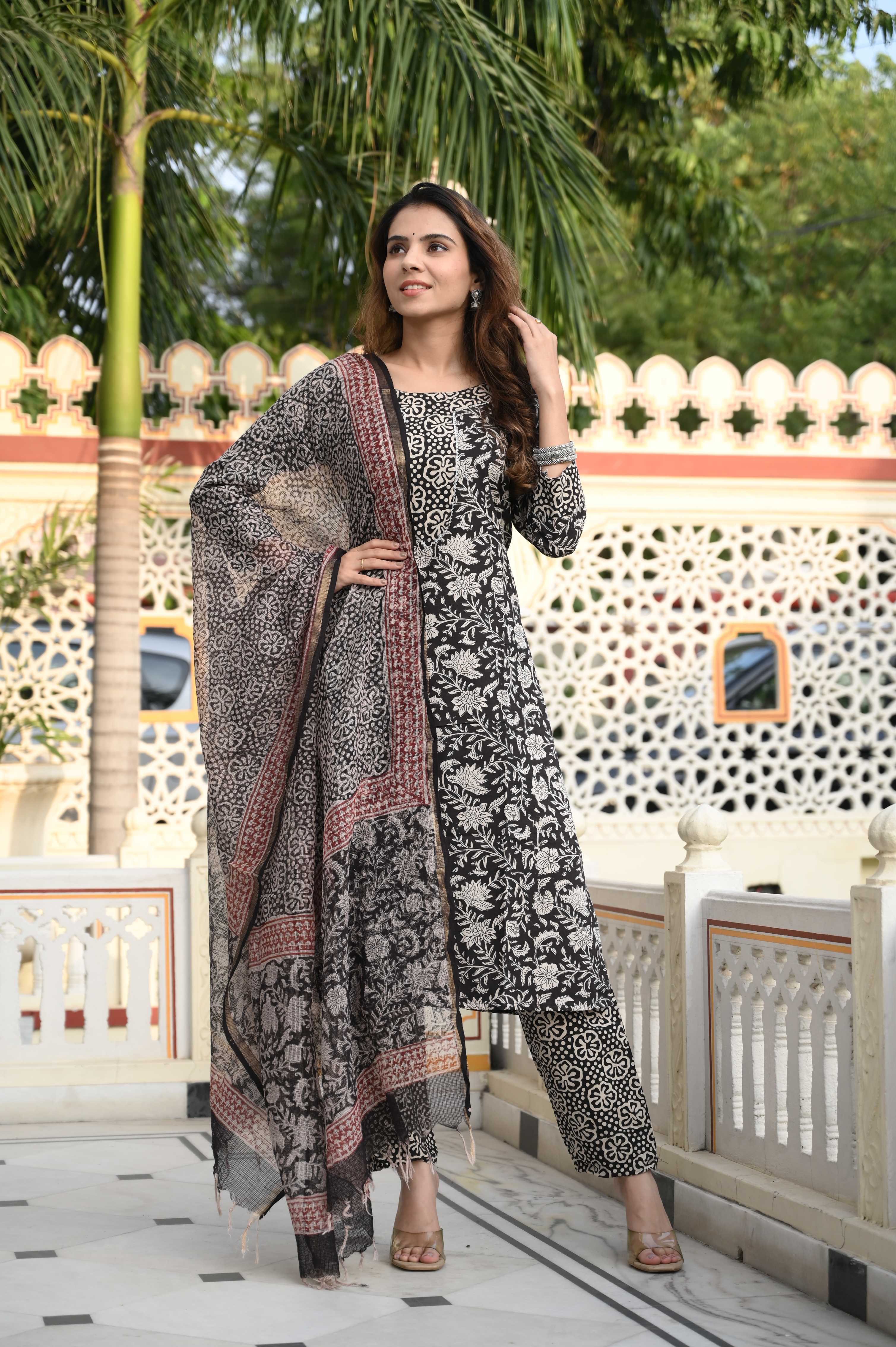 Traditional handcrafted cotton suit set featuring intricate ethnic prints and a coordinated dupatta.