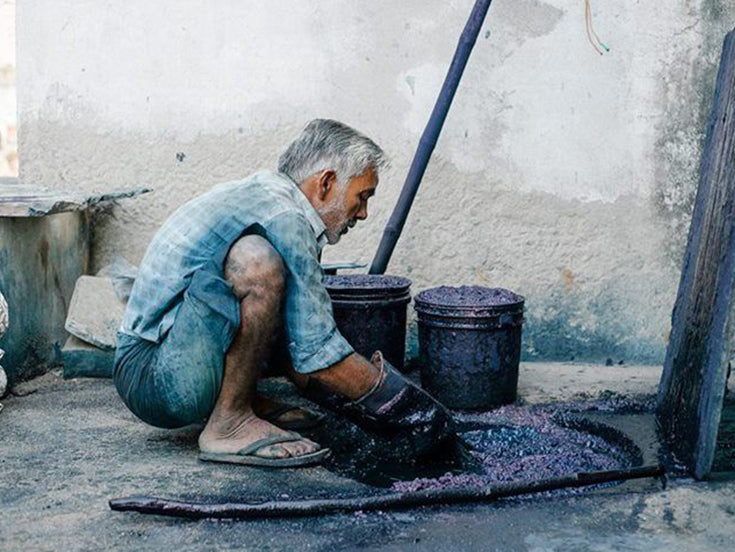 Master artisan in Jaipur performing traditional hand-block printing for Kimaari clothing.
